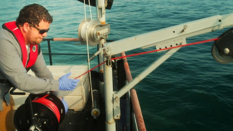 MMSD Water Resources Technician taking a sample in Lake Michigan 