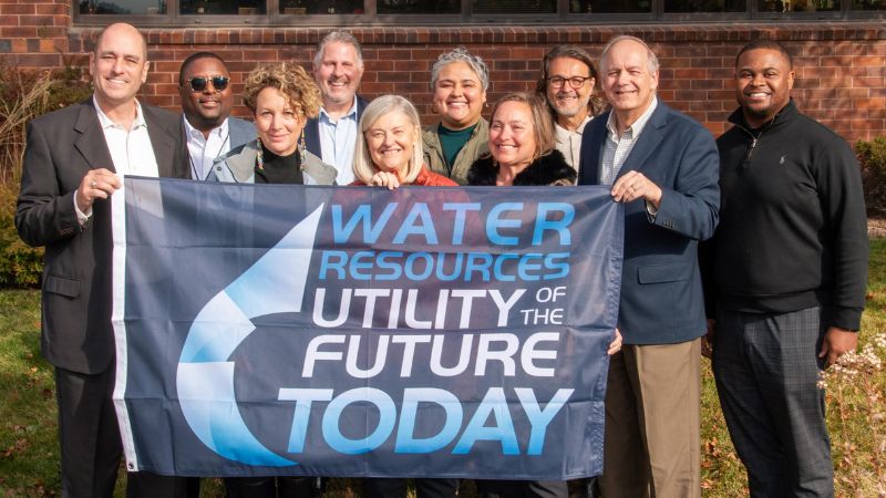 MMSD commissioners holding the 2024 utility of the year banner