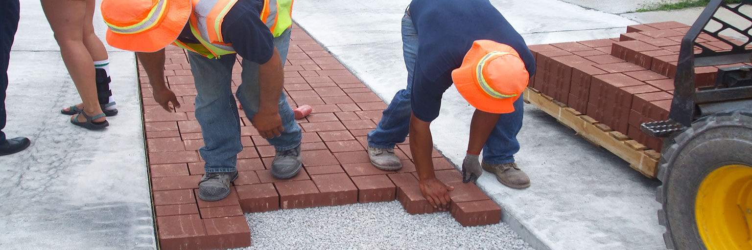 Workers installing porous pavement 