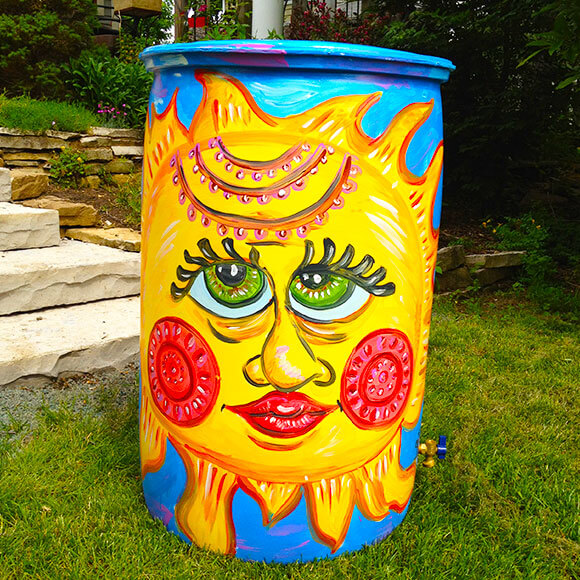 rain barrel painted with a bright sun